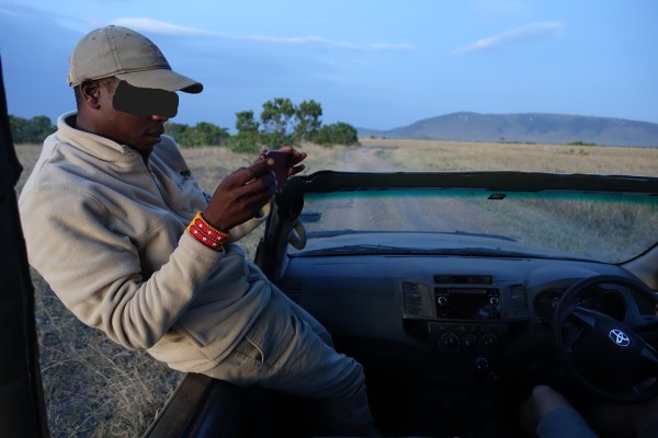 A safari guide holding a smartphone